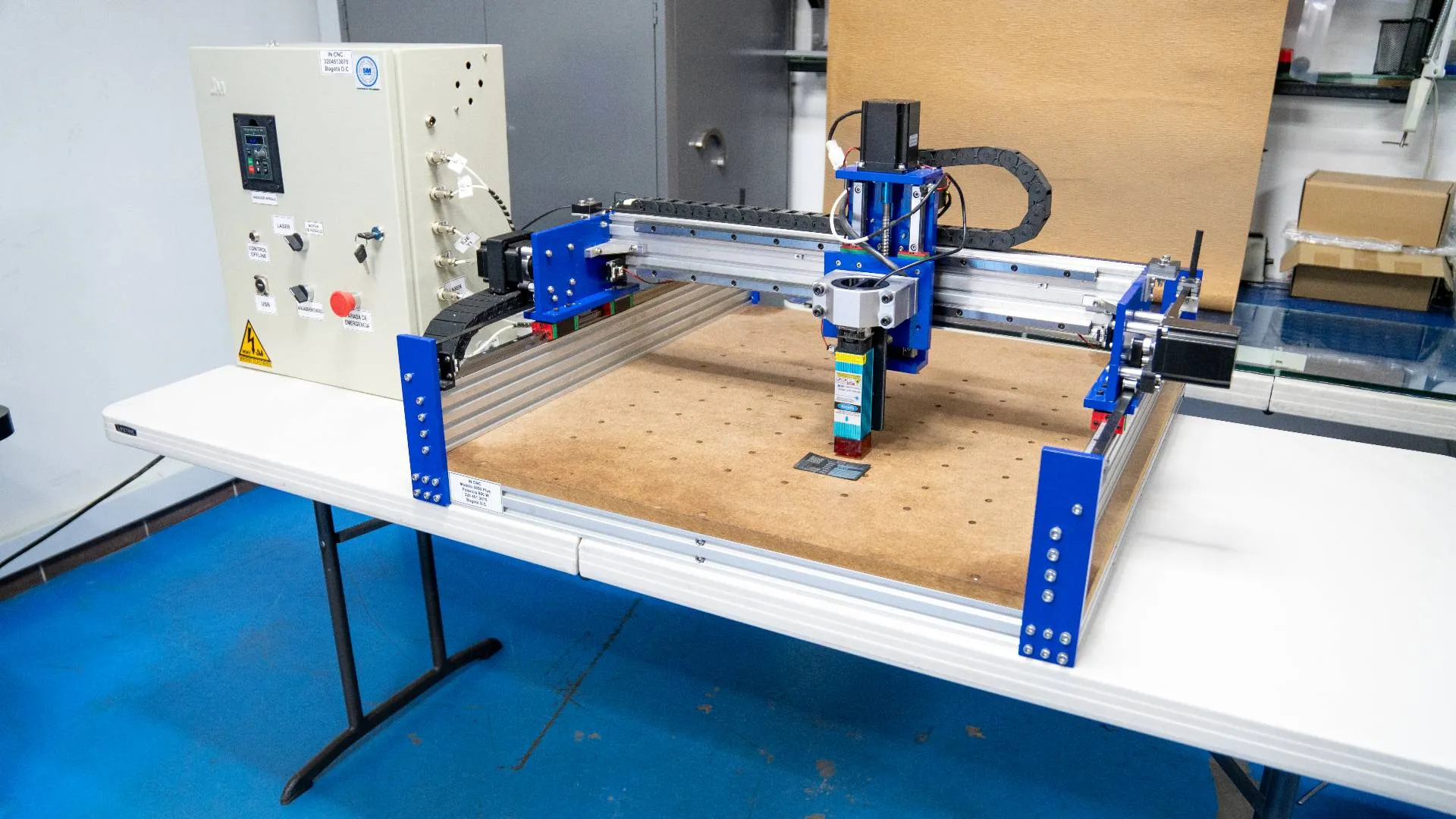 On a table, a machine is placed alongside a blue machine, emphasizing their different appearances and functionalities